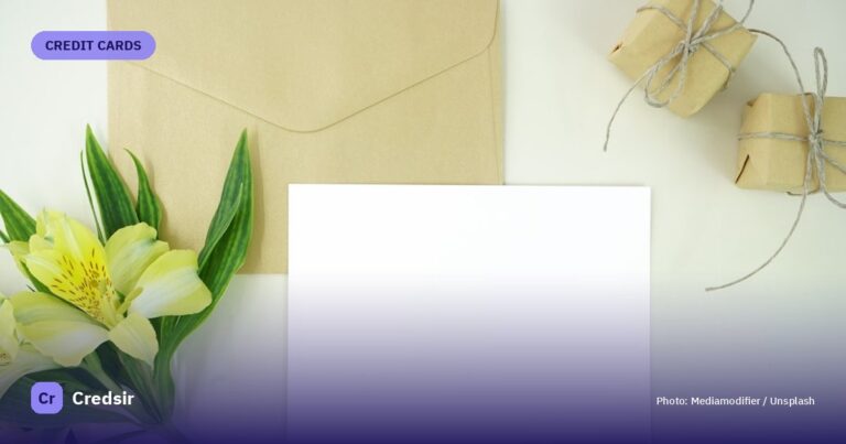 White paper beside green flower — cover photo for Credsir’s Credit Card Cash Withdrawal Charges guide