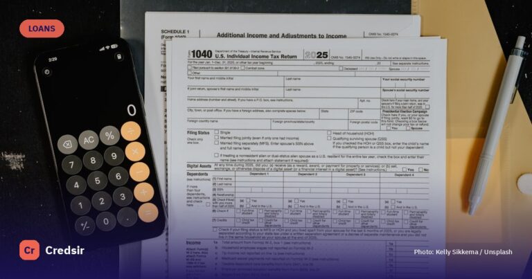 Tax forms and calculator on a desk — cover photo for Credsir’s Loan Refinancing guide