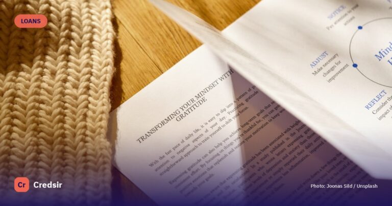 A pair of scissors laying on top of a piece of paper — cover photo for Credsir’s Personal Loan EMI Calculator guide
