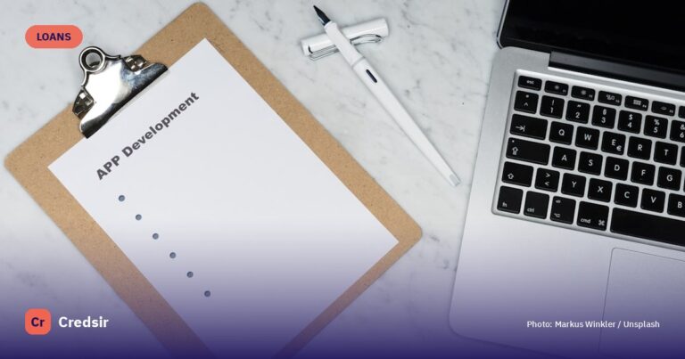 White printer paper beside silver key — cover photo for Credsir’s Personal Loan Interest Rates guide
