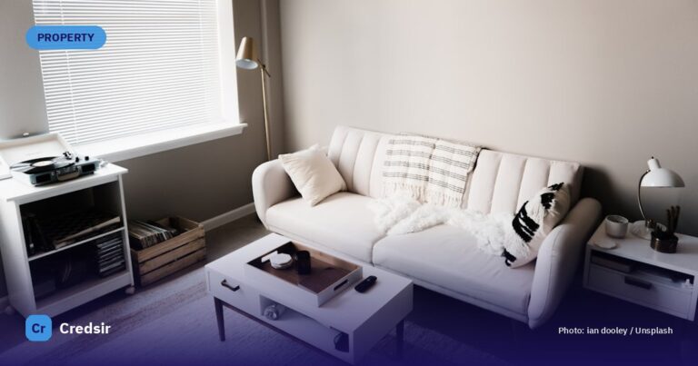 White couch in front of white wooden table — cover photo for Credsir’s AP Property Tax guide
