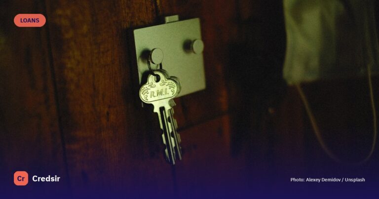 A key is attached to a wooden door — cover photo for Credsir’s Mortgage Affordability Calculator guide
