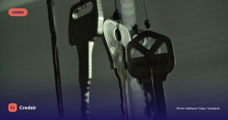 Black and silver keys on white wooden table — cover photo for Credsir’s Startup Business Loan guide