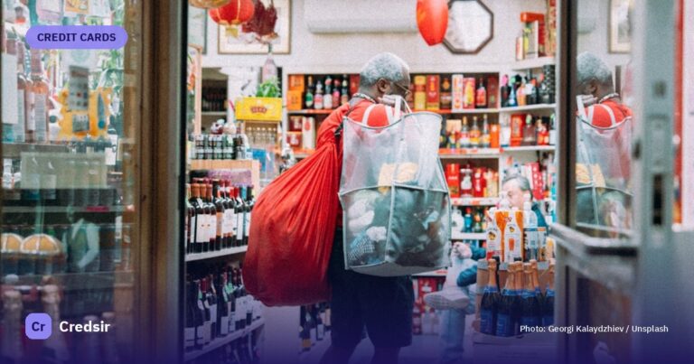 Shopper with large bags leaving a new york store — cover photo for Credsir’s YES Bank Credit Cards guide